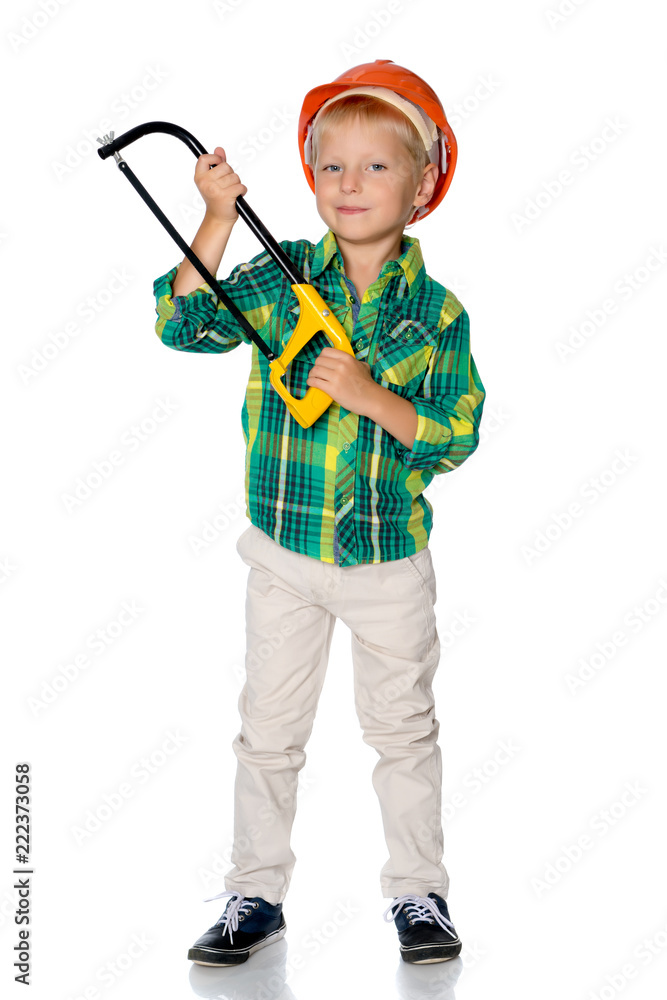 The little boy in the helmet of the builder. The little boy in the helmet of the builder.