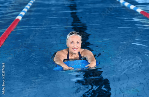 Sportive senior woman in indoor swimming pool