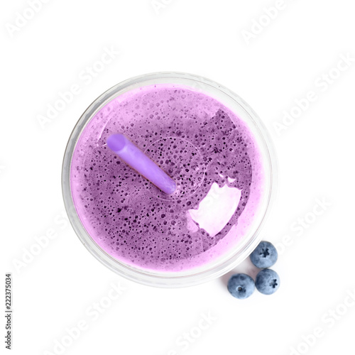 Tasty blueberry smoothie in plastic cup on white background, top view
