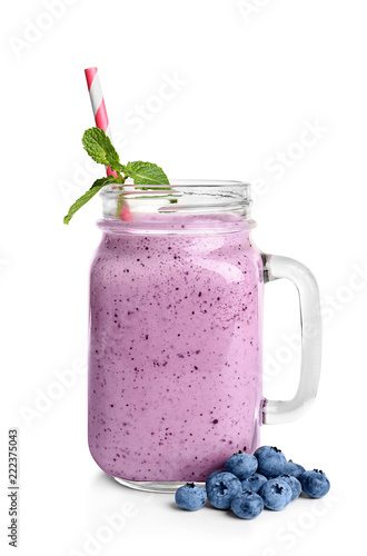 Tasty blueberry smoothie in mason jar on white background