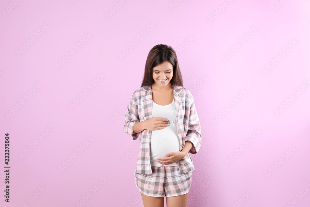 Happy pregnant woman posing on color background Happy pregnant woman posing on color background