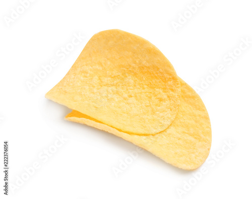Tasty crispy potato chips on white background