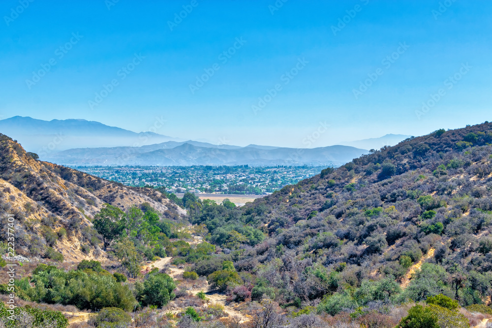 Trails for hiking and biking above Southern California suburbs with houses in the distance
