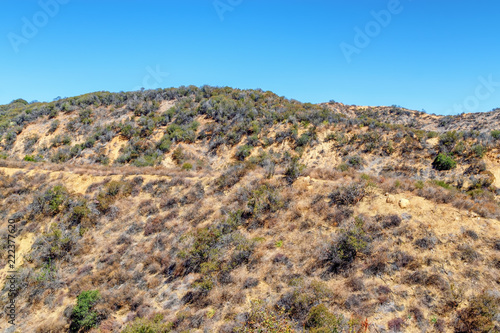 Hiking and biking trail in middle of dry California mountain hillsides