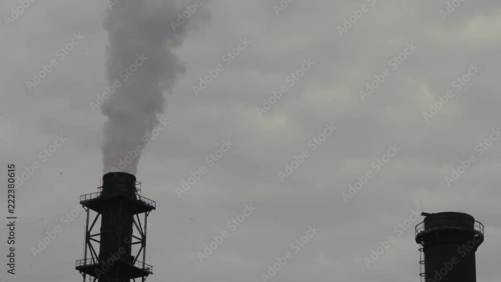 A big stovepipe smokes on the mining and processing plant A big stovepipe smokes on the mining and processing plant