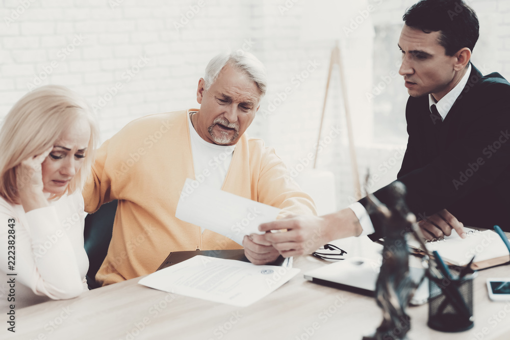 Old Man and Woman Visiting Young Lawyer in Office. Old Man and Woman Visiting Young Lawyer in Office.