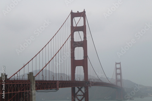 The Golden Gate bridge as it spans across the San Francisco Bay  #222383432
