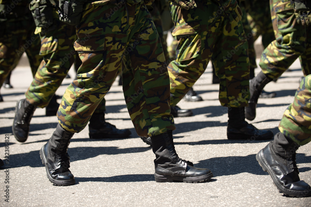 Military marching in a street. Legs and shoes in line Military marching in a street. Legs and shoes in line