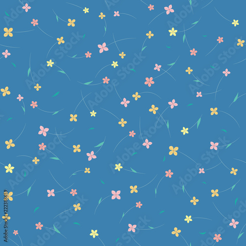 Seamless floral pattern with small flowers in soft pastel colors on blue background. Ditsy print.
