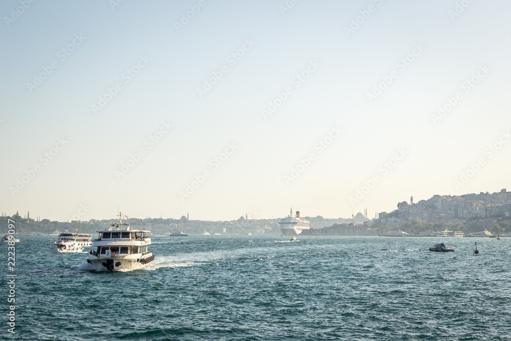 ISTANBUL, TURKEY - JULY 10, 2014: Passenger ferry ship carries people across the Bosphorus Strait along Istanbul, Turkey
