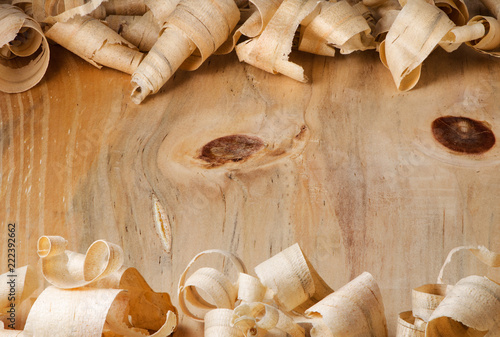 Wood shavings over a wooden surface background