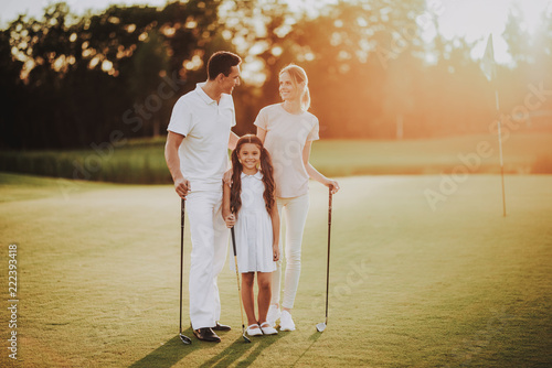 Happy Young Family Relax on Golf Field in Summer.