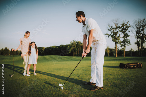 Happy Young Family Relax on Golf Field in Summer.