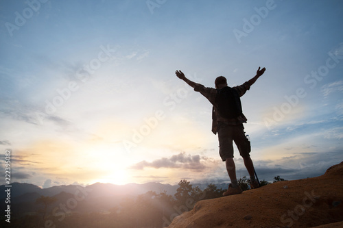 Wallpaper Mural Man silhouette stand alone on the mountain and watching romantic colorful sunrise Torontodigital.ca