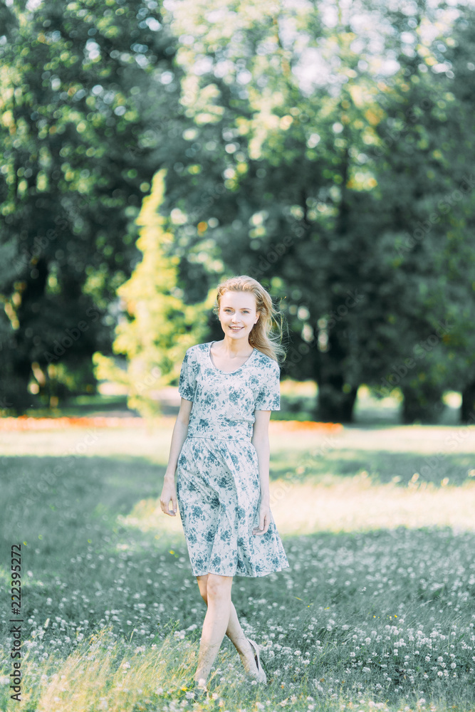 beautiful girl in the Park, in a summer dress and walking. Smiles and enjoys nature. St. Petersburg, Yelagin island beautiful girl in the Park, in a summer dress and walking. Smiles and enjoys nature. St. Petersburg, Yelagin island