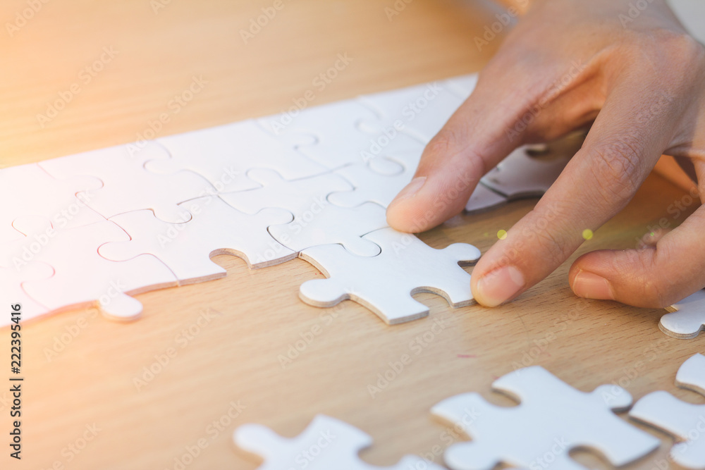 Close up of hands business women connecting jigsaw puzzleon, Teamwork workplace success and strategy concept. Close up of hands business women connecting jigsaw puzzleon, Teamwork workplace success and strategy concept.