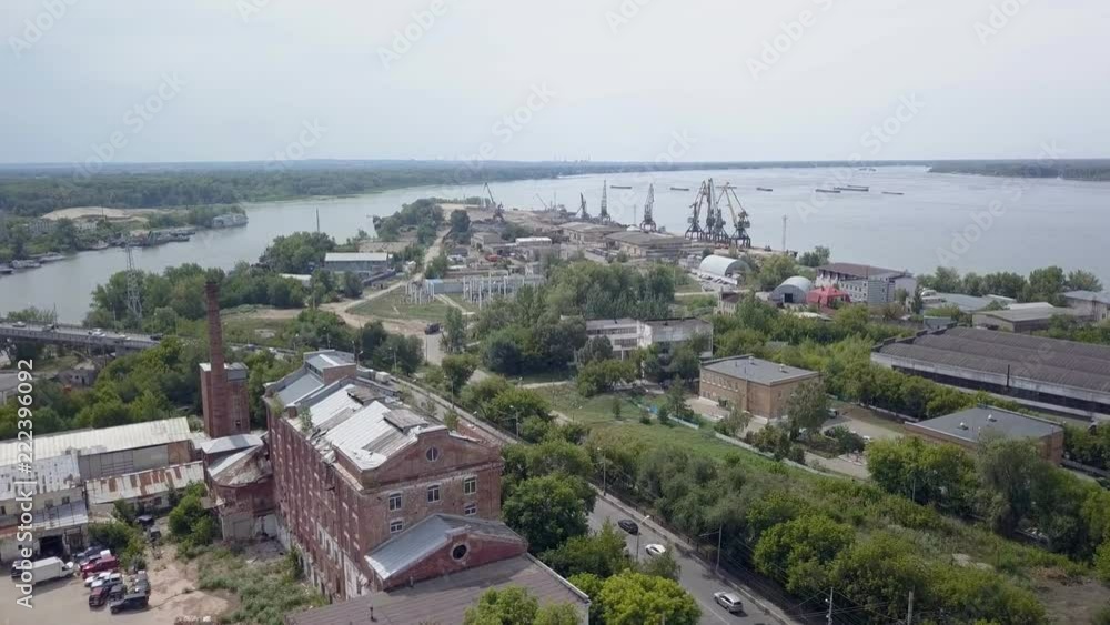 drone is flying over industrial area in city, old buildings and construction cranes drone is flying over industrial area in city, old buildings and construction cranes
