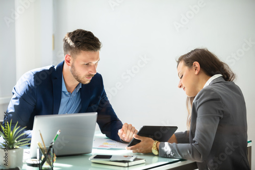 Fotografie Two Businesspeople Using Digital Tablet