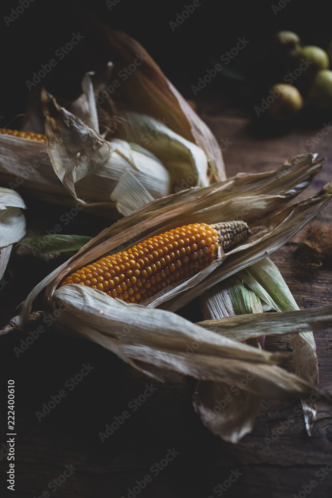 picturesque, ripe, yellow corn on the background of a board