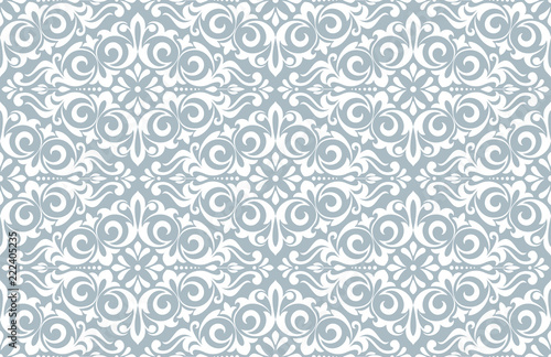 Wallpaper in the style of Baroque. Seamless vector background. White and blue floral ornament. Graphic pattern for fabric, wallpaper, packaging. Ornate Damask flower ornament