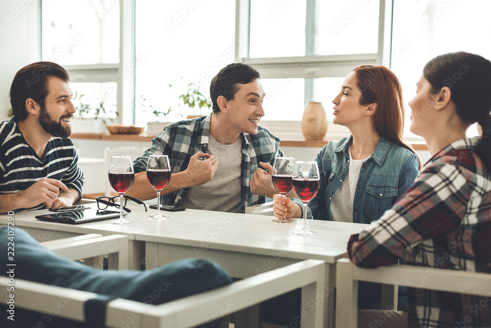 After work. Joyful positive people drinking wine while meeting in the cafe after work After work. Joyful positive people drinking wine while meeting in the cafe after work