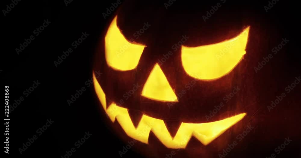 Halloween pumpkin with scary face with with a burning candle Halloween pumpkin with scary face with with a burning candle