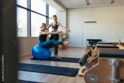 Women practicing pilates workout at a gym