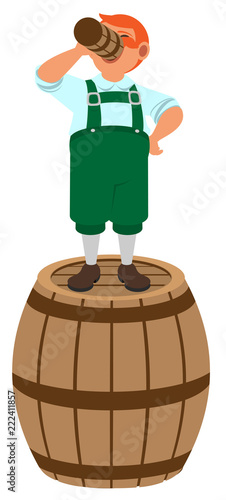 Red haired German leprechaun stands on wooden barrel and drinks beer