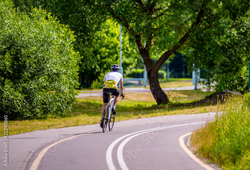 Wallpaper Mural Cyclist ride on the bike path in the city Park  Torontodigital.ca