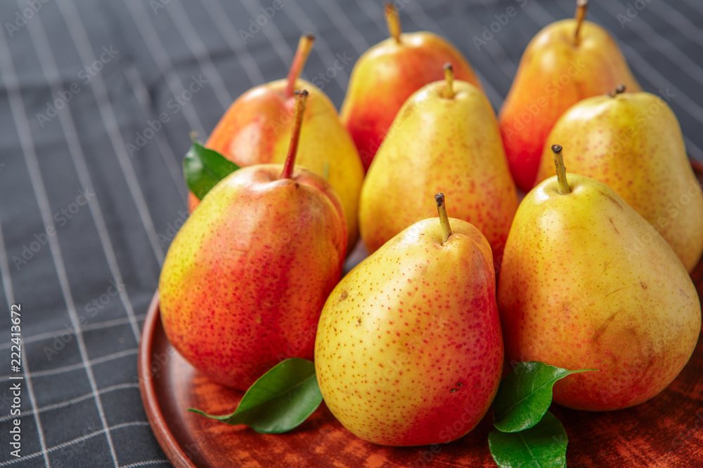 organic pears laying down on a lightly dotted kitchen cloth