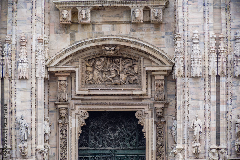 Details of windows, doors, sculpture, facade on exterior of Duomo di Milano