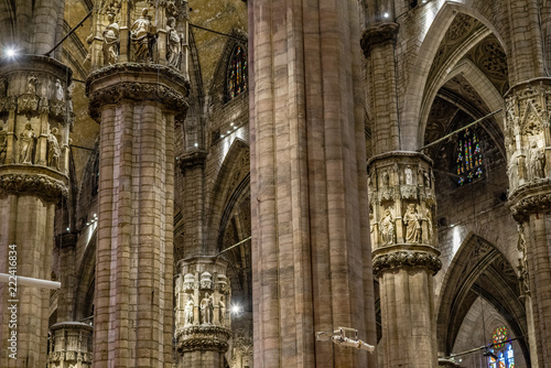 Center Nave columns inside interior Duomo di Milano. with statues serving crowns