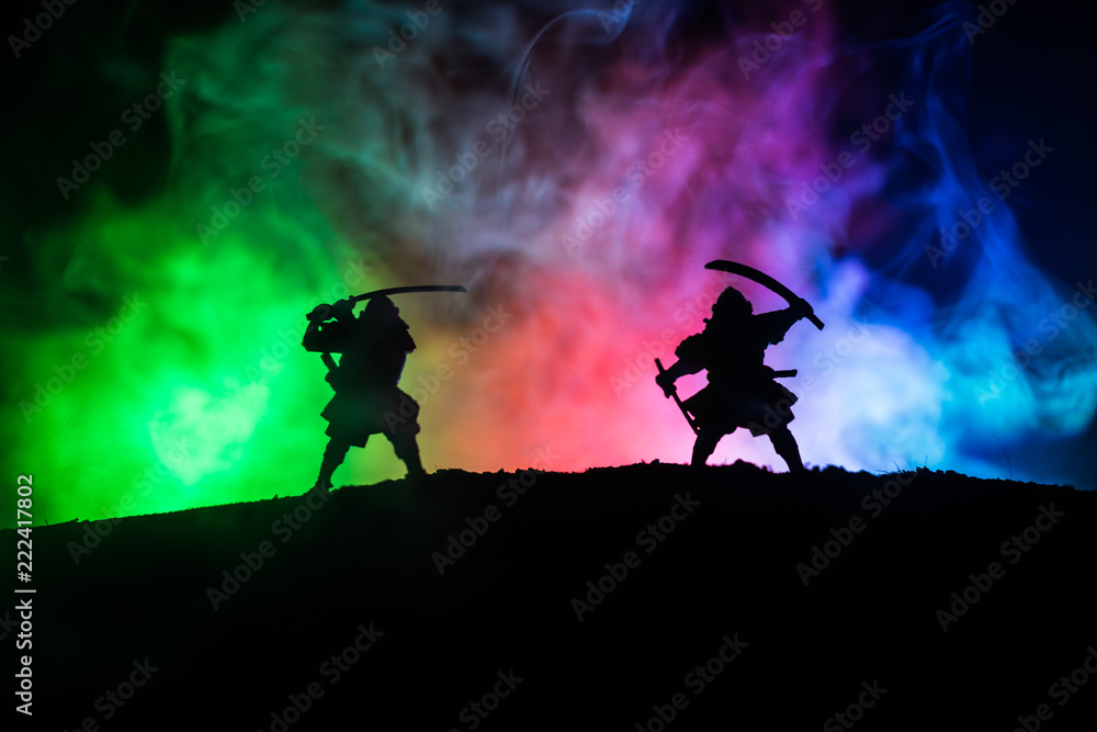 Fototapeta premium Silhouette of two samurais in duel. Picture with two samurais and sunset sky