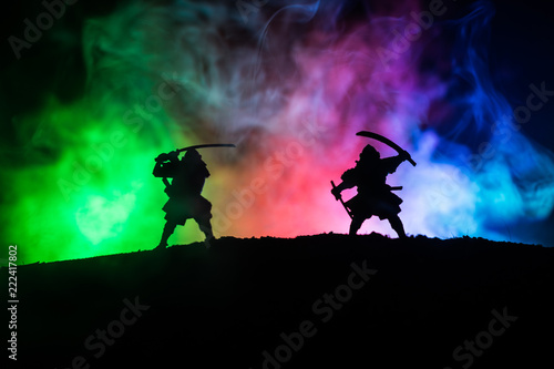 Silhouette of two samurais in duel. Picture with two samurais and sunset sky