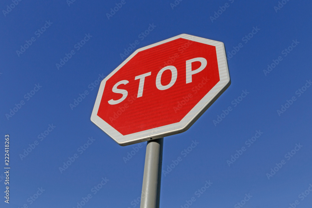 road sign stop on post against blue sky road sign stop on post against blue sky
