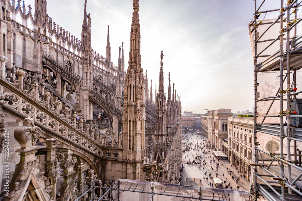 Rooftop view of spires, sculpture, cathederal, and construction of the Duomo di Milano
