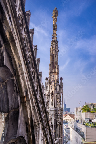 Vertical: Rooftop view of spires, sculpture, cathederal, and Milan from the Duomo di Milano © skyoftexas