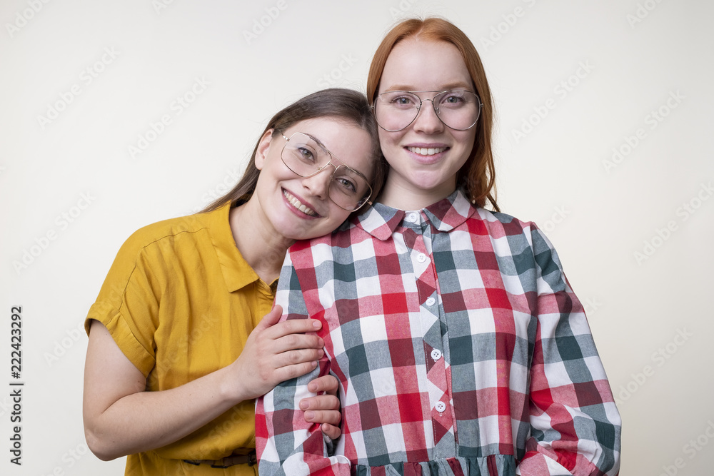 Smiling beautiful young woman embracing girlfriend Smiling beautiful young woman embracing girlfriend