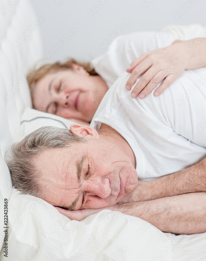 elderly couple sleeping together on the bed elderly couple sleeping together on the bed