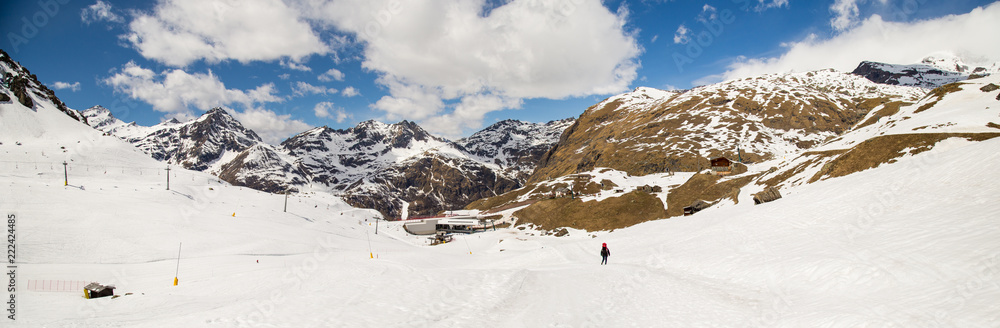 Alone trekker walks in a snowy valley