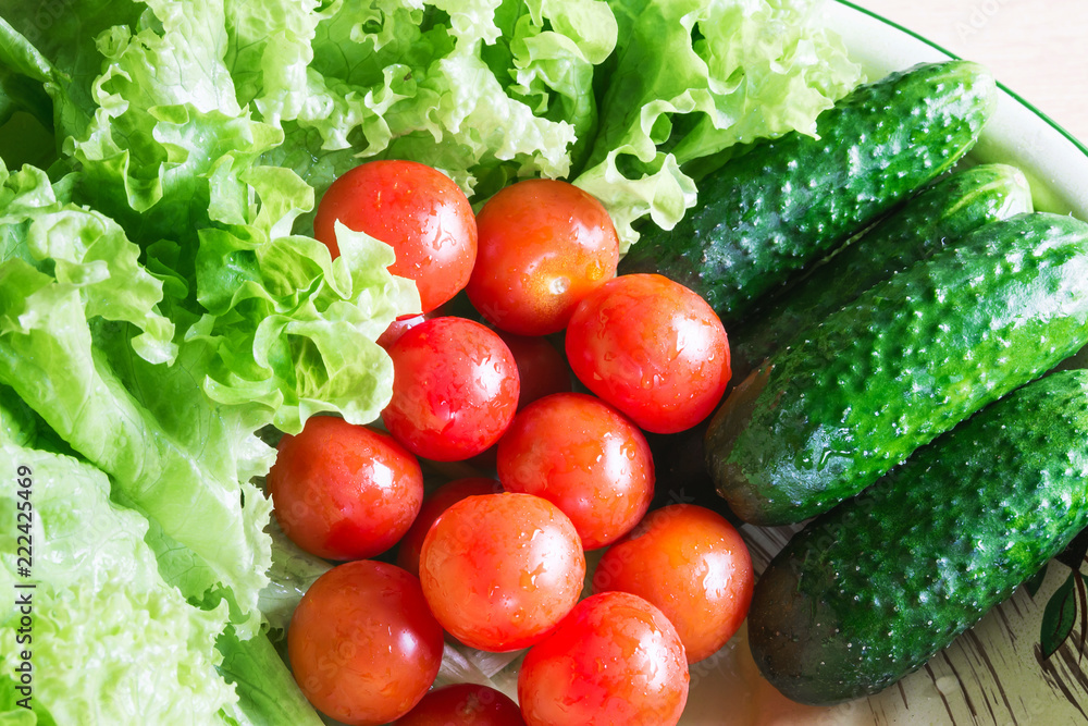 The concept of healthy eating. Background with vegetables. Green salad and tomatoes