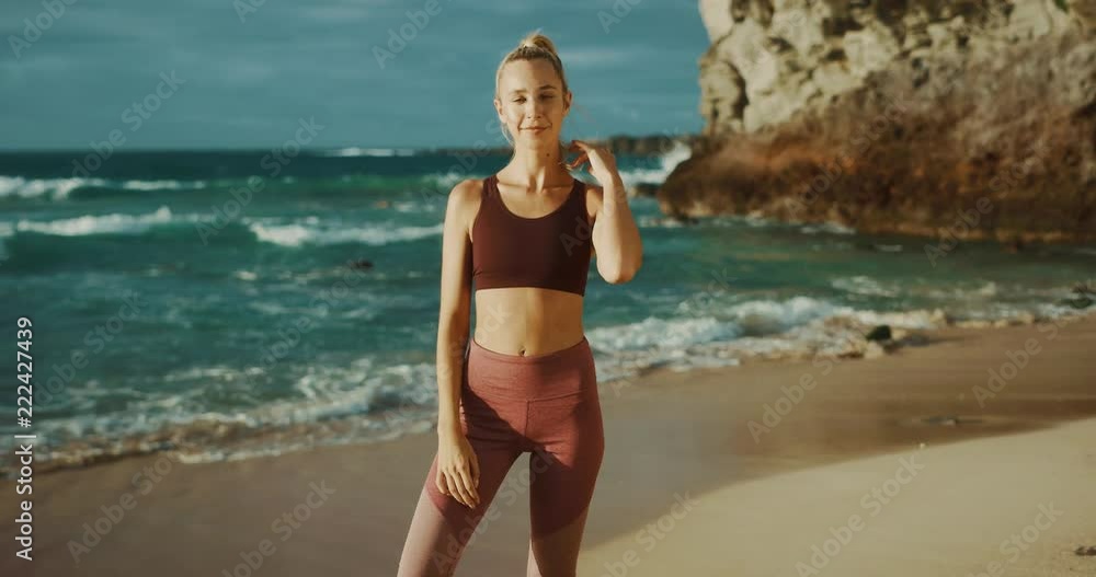 Fitness lifestyle of beautiful young woman at the beach