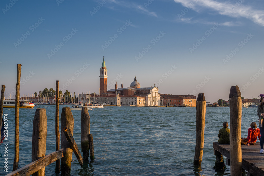 Dock side view of beautiful sunset light on San Giorgio Maggiore across from Venice, Italy