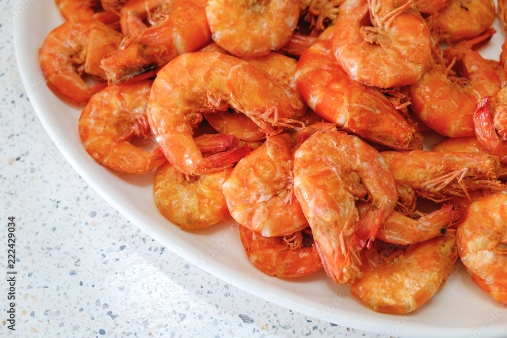 Cooked Fresh Shrimps on a White Plate Over Stone Table. Fresh and Healthy Seafood Cooked Fresh Shrimps on a White Plate Over Stone Table. Fresh and Healthy Seafood