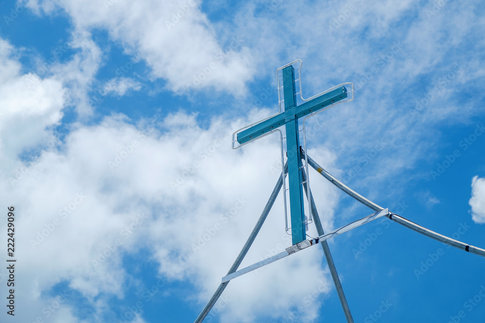 Real Simple Cross Sign with Light all Around in the Beautiful Clear Blue Sky with Clouds Real Simple Cross Sign with Light all Around in the Beautiful Clear Blue Sky with Clouds