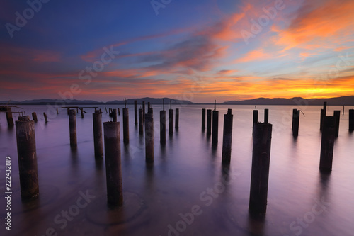 Abandoned concrete pillars on the sea in the beautiful sunrise 