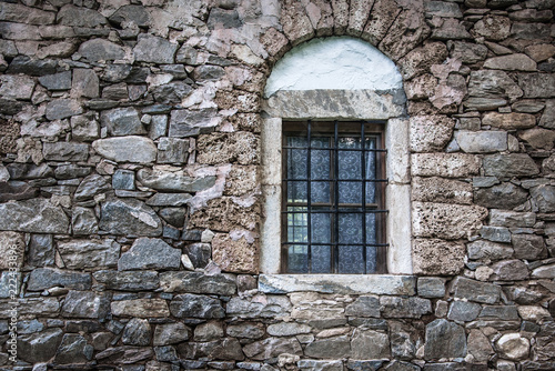 wall of the old stone house with window for your design © drutska