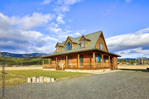 Nice wooden ranch home with beautiful landscape in the countryside.