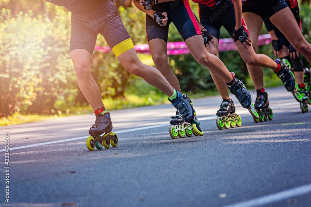 Inline roller skaters racing in the park o