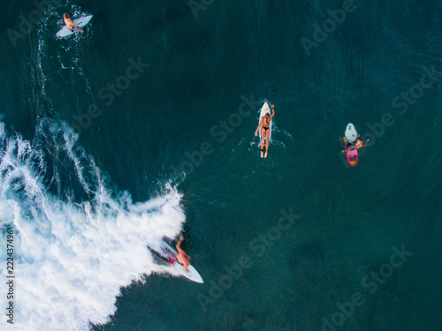 surfer canggu bali aerial shot paddle surf